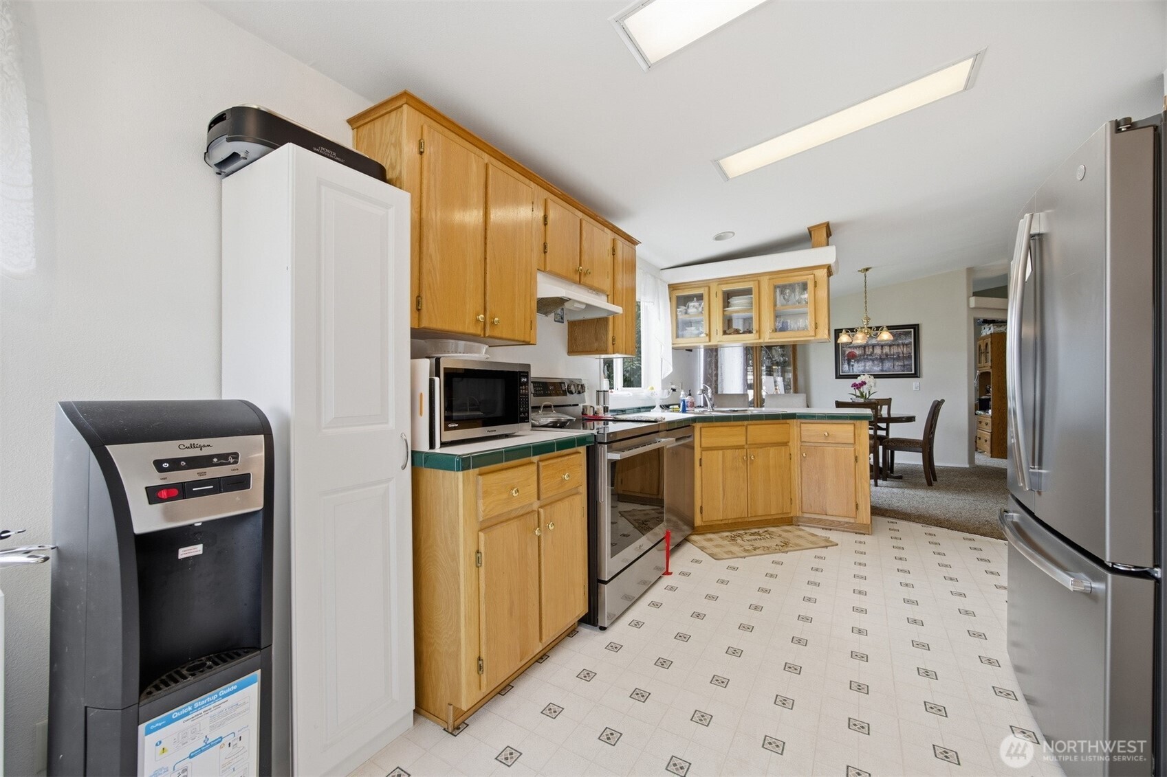 380 East Pole Road, Unit 6 Lynden, WA 98264 - Photo 16 of 40 a kitchen with stainless steel appliances a refrigerator sink and microwave