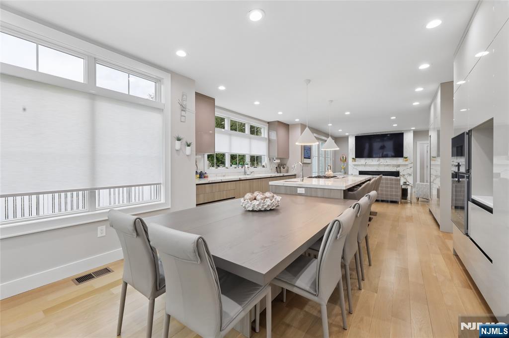 31 Engleside Street Cresskill, NJ 07626 - Photo 15 of 49 a dining room with stainless steel appliances a table and chairs