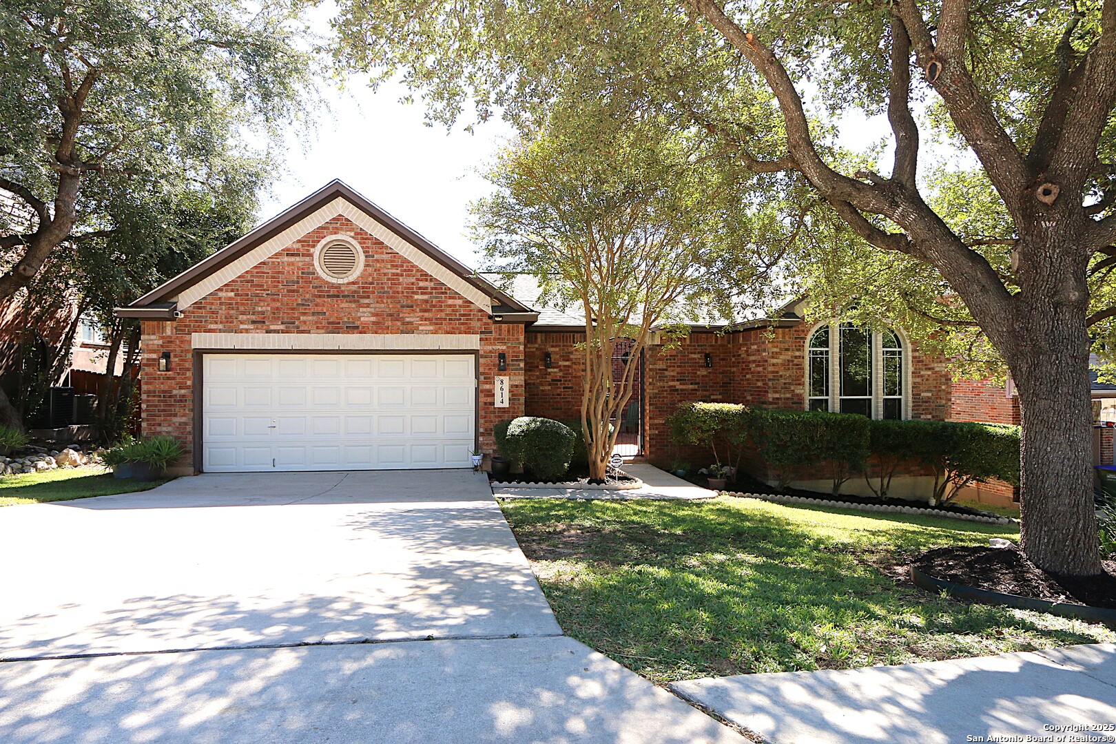 8614 Mantano Ridge Helotes, TX 78023 - Photo 1 of 36 a front view of a house with a yard and garage