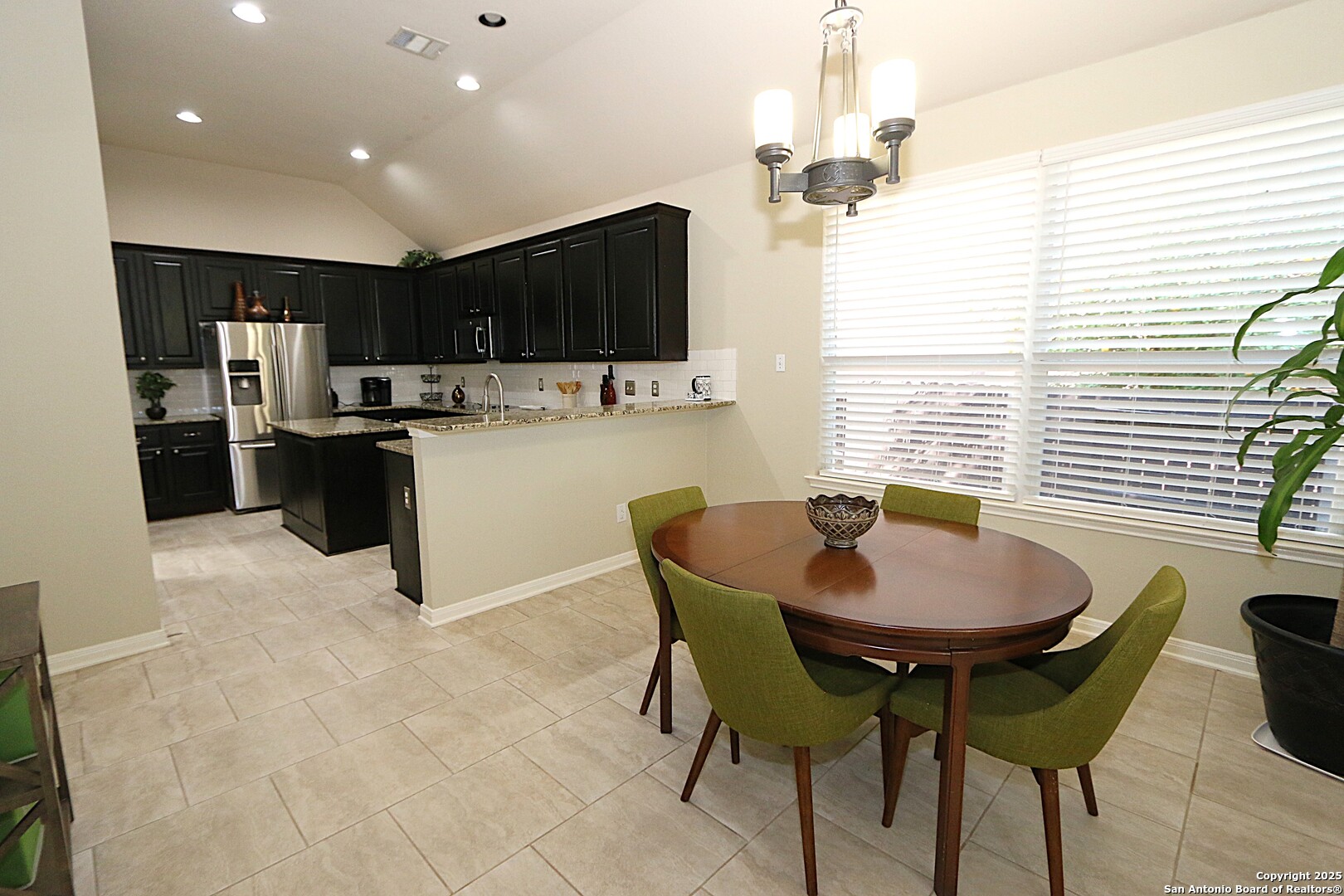 8614 Mantano Ridge Helotes, TX 78023 - Photo 12 of 36 a kitchen with a dining table and chairs