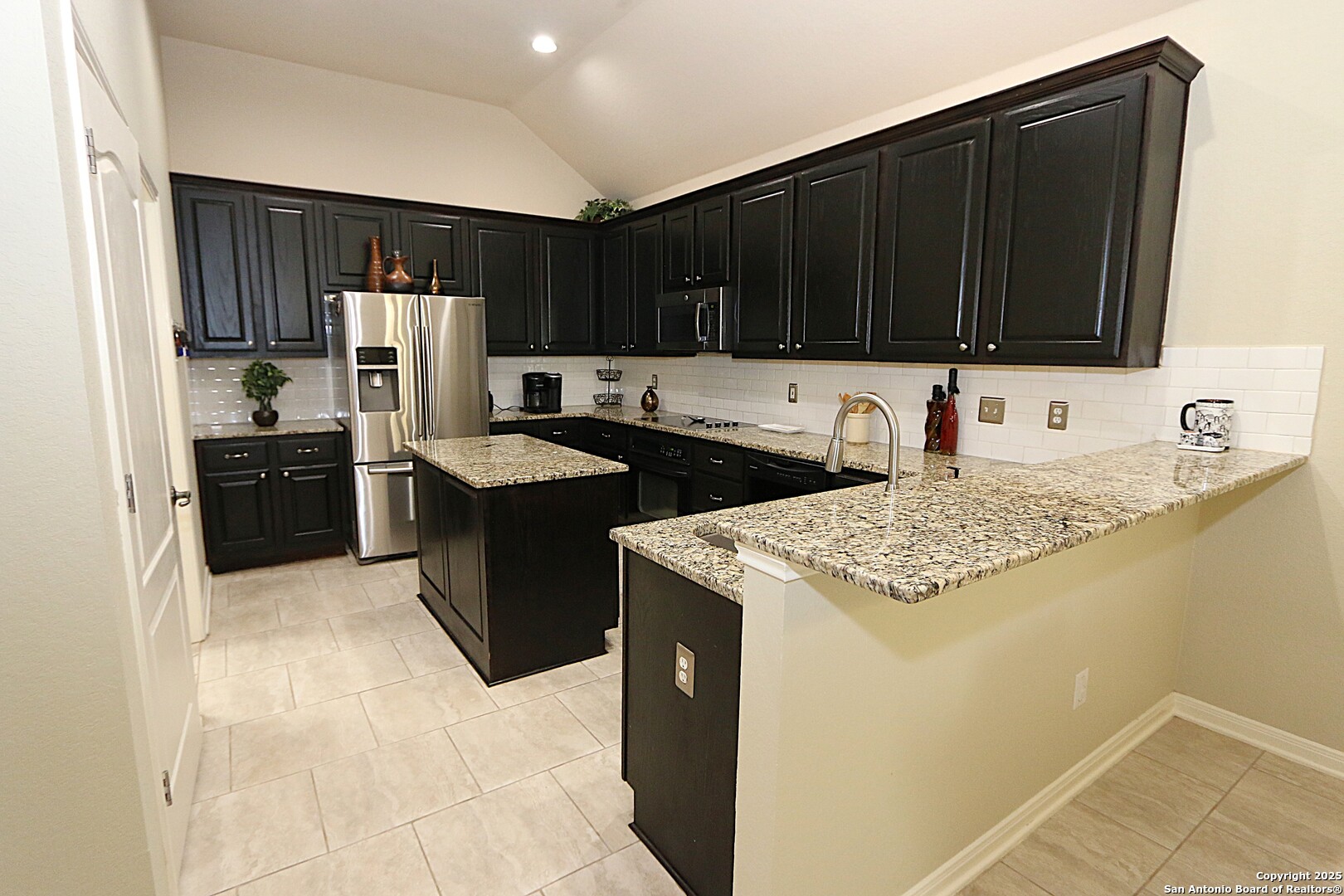 8614 Mantano Ridge Helotes, TX 78023 - Photo 13 of 36 a kitchen with a sink and a refrigerator