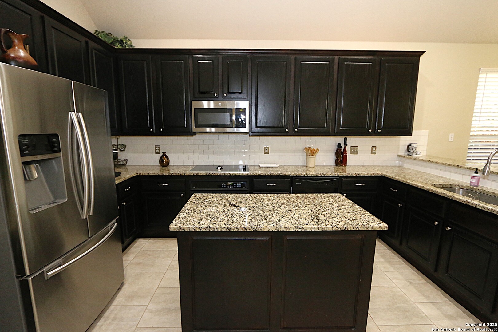 8614 Mantano Ridge Helotes, TX 78023 - Photo 14 of 36 a kitchen with a sink stove and refrigerator