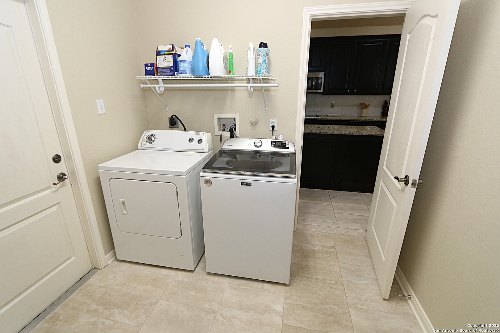8614 Mantano Ridge Helotes, TX 78023 - Photo 16 of 36 a utility room with dryer and washer