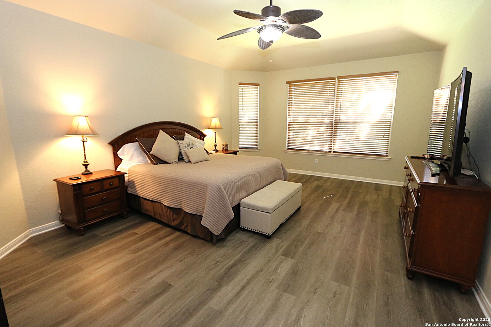 8614 Mantano Ridge Helotes, TX 78023 - Photo 18 of 36 a bedroom with a bed and a flat tv screen on dresser