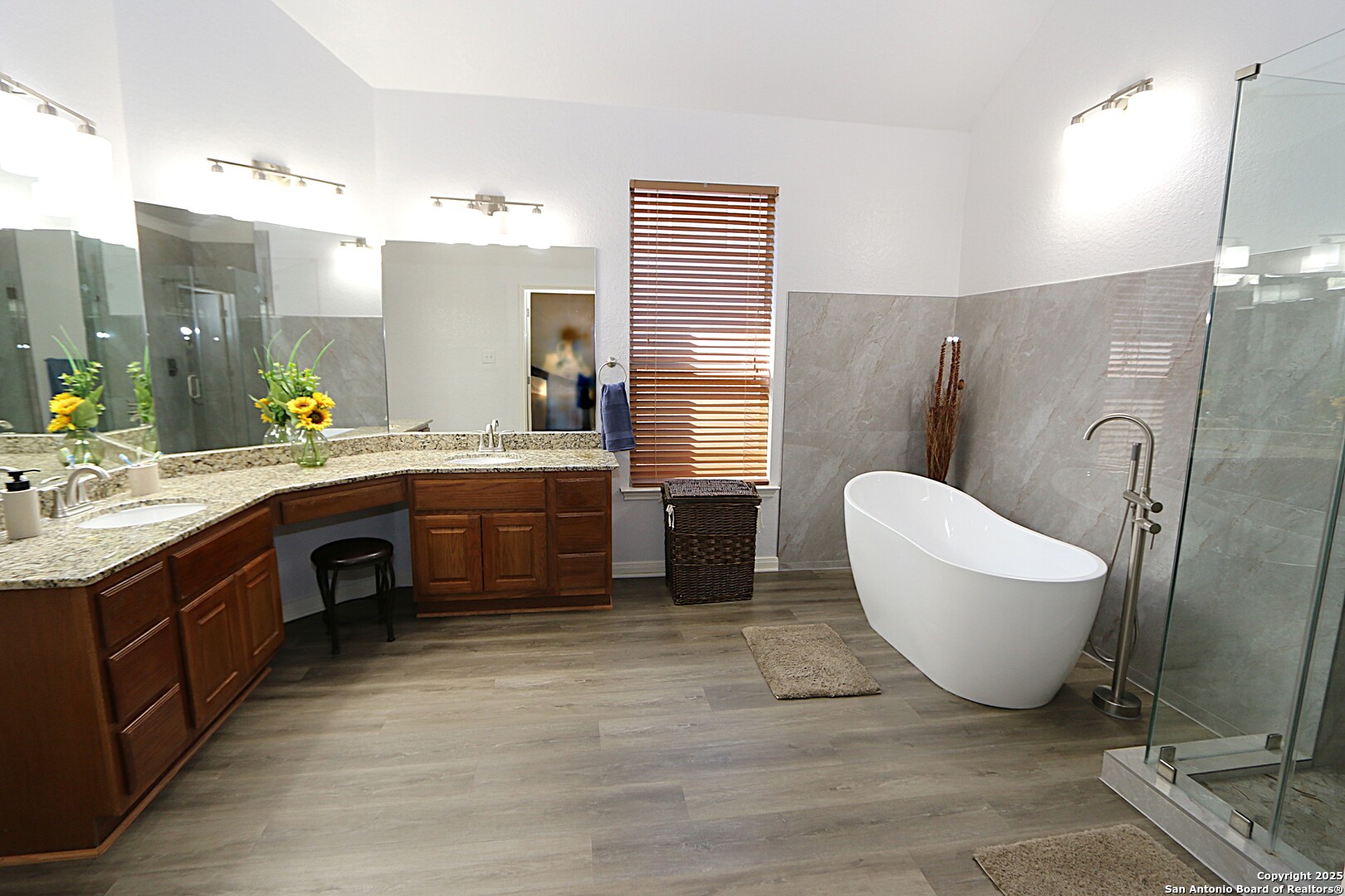 8614 Mantano Ridge Helotes, TX 78023 - Photo 20 of 36 a spacious bathroom with a double vanity sink a mirror and a bathtub