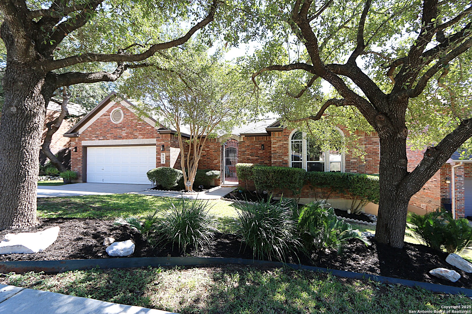 8614 Mantano Ridge Helotes, TX 78023 - Photo 2 of 36 a front view of a house with garden