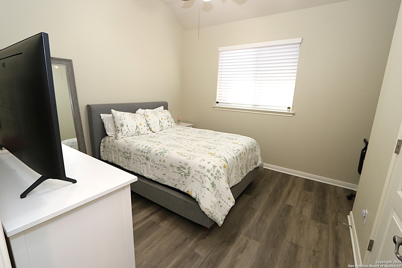 8614 Mantano Ridge Helotes, TX 78023 - Photo 25 of 36 a bedroom with a bed and a flat screen tv
