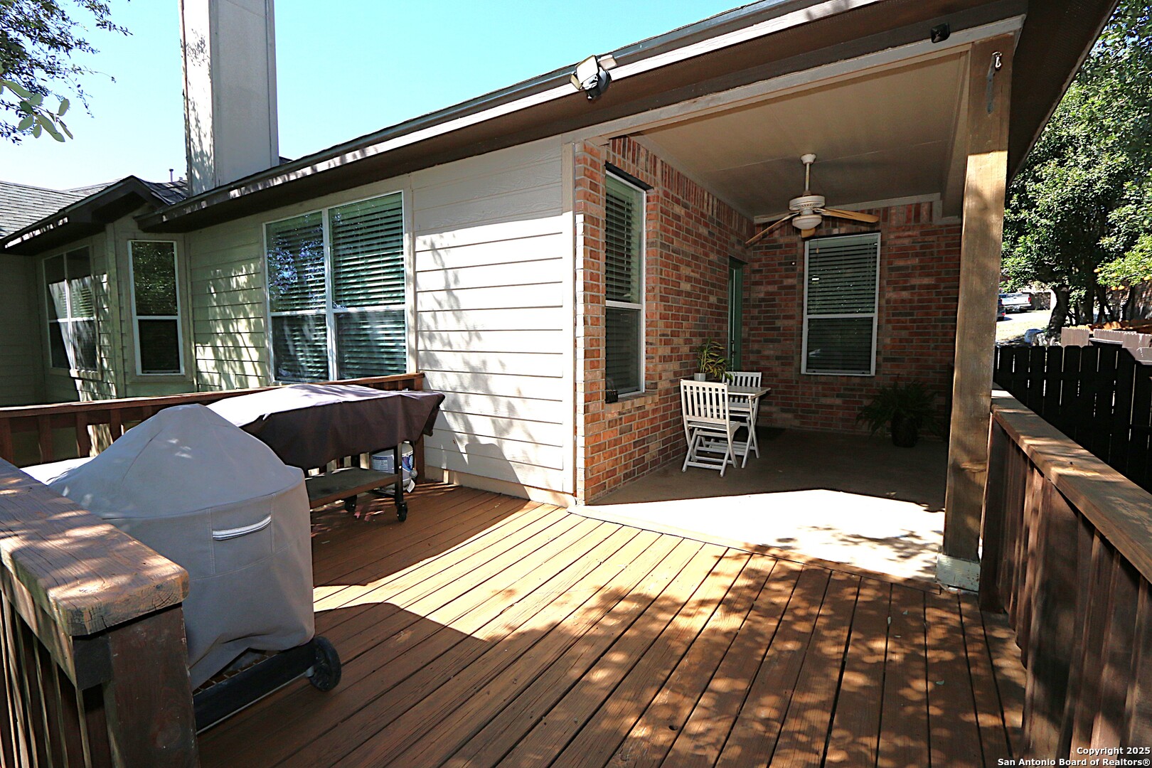 8614 Mantano Ridge Helotes, TX 78023 - Photo 29 of 36 a view of backyard with outdoor seating and wooden floor