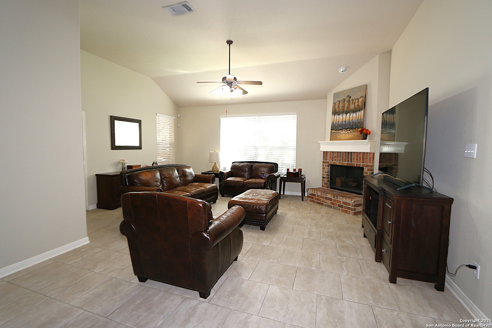 8614 Mantano Ridge Helotes, TX 78023 - Photo 8 of 36 a living room with furniture a fireplace and a flat screen tv