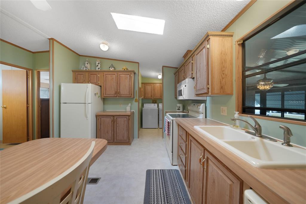 10101 Burnt Store Road, Unit 54 Punta Gorda, FL 33950 - Photo 14 of 28 a kitchen with a sink refrigerator and a sink