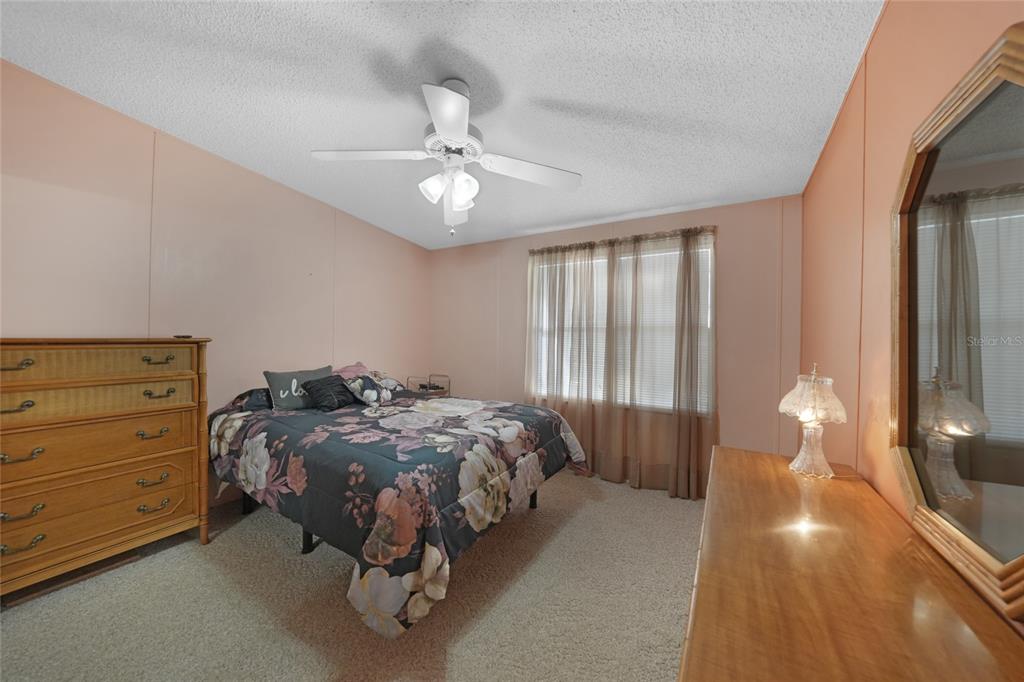 10101 Burnt Store Road, Unit 54 Punta Gorda, FL 33950 - Photo 20 of 28 a bed sitting in a bedroom next to a window