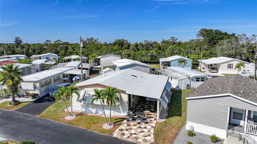 10101 Burnt Store Road, Unit 54 Punta Gorda, FL 33950 - Photo 2 of 28 a view of a patio with table and chairs with wooden floor and fence