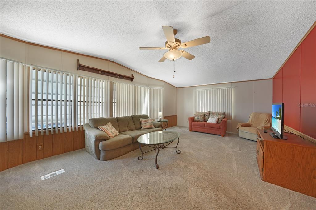 10101 Burnt Store Road, Unit 54 Punta Gorda, FL 33950 - Photo 8 of 28 a living room with furniture and a large window