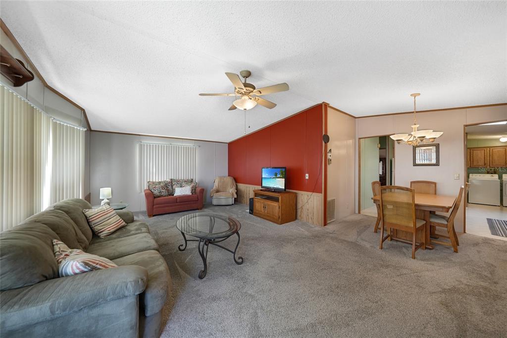 10101 Burnt Store Road, Unit 54 Punta Gorda, FL 33950 - Photo 10 of 28 a living room with furniture and a ceiling fan