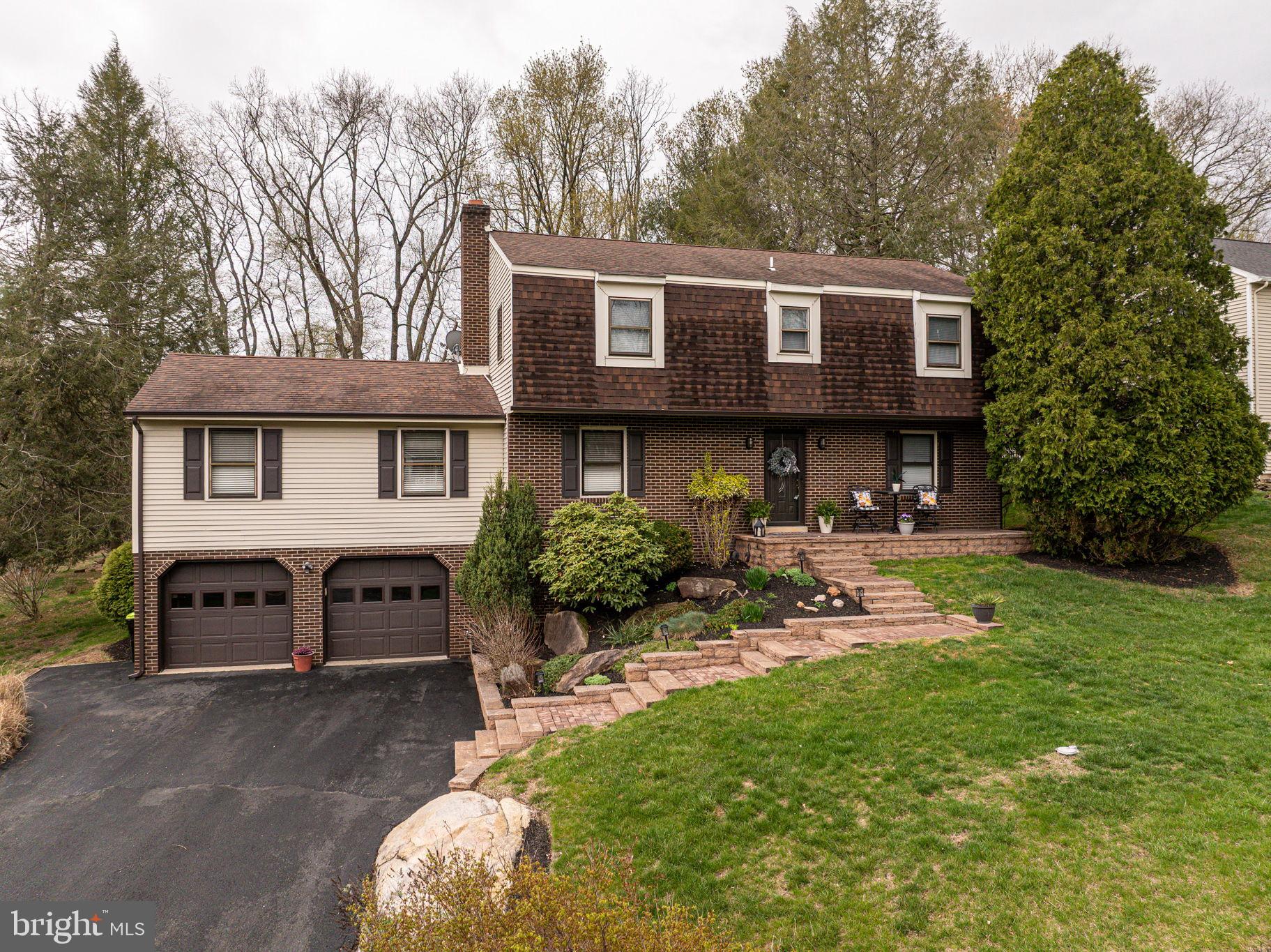 a view of a house with backyard sitting area and garden