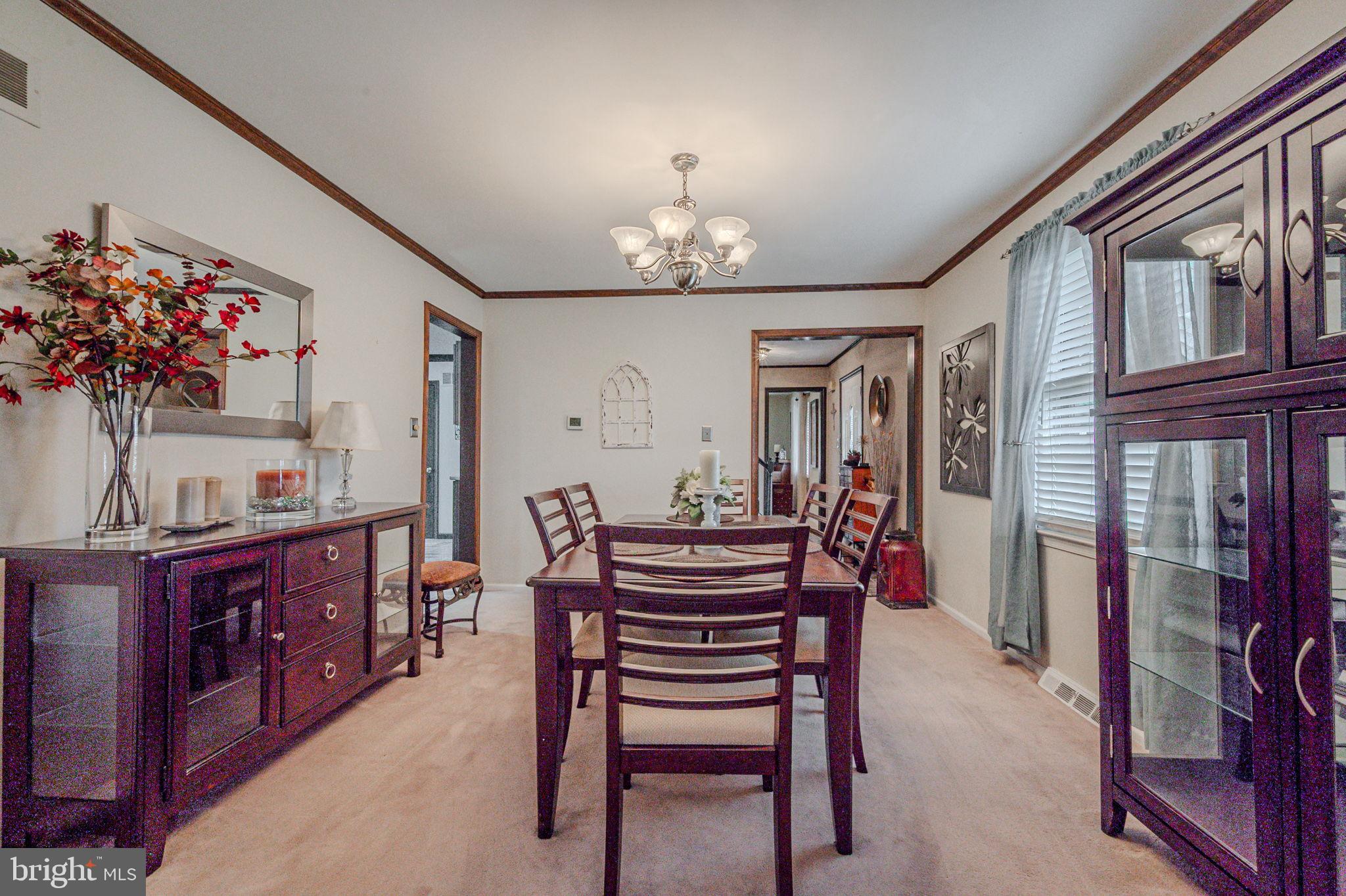211 Old Ashley Drive Elkton, MD 21921 - Photo 12 of 50 a view of a dining room with furniture and chandelier