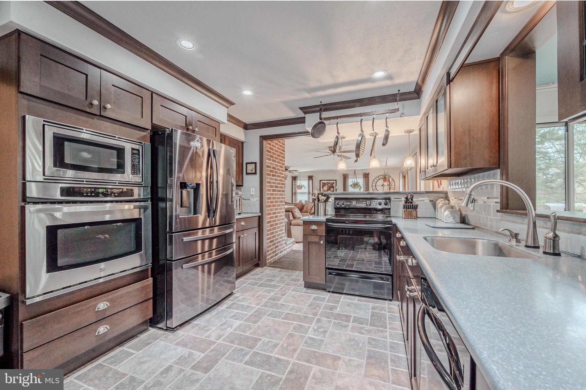 211 Old Ashley Drive Elkton, MD 21921 - Photo 20 of 50 a kitchen with stainless steel appliances granite countertop a stove refrigerator and kitchen island