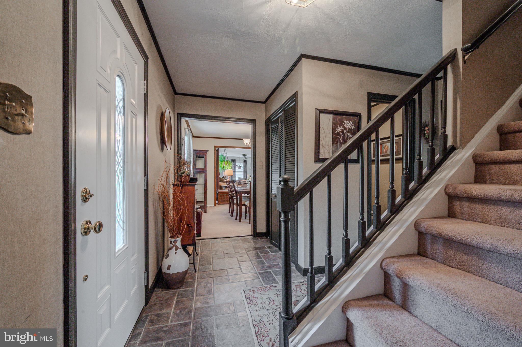 211 Old Ashley Drive Elkton, MD 21921 - Photo 2 of 50 a view of a hallway with wooden floor and staircase