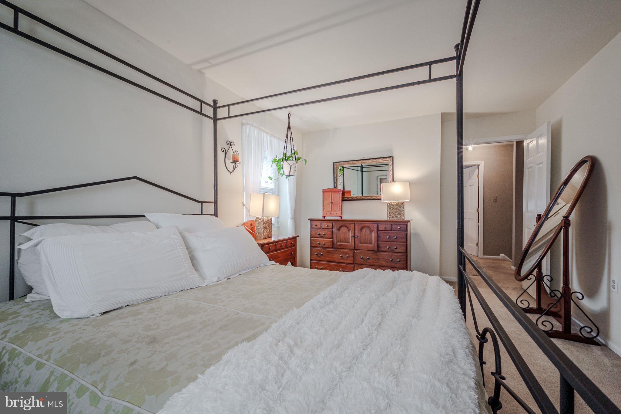 211 Old Ashley Drive Elkton, MD 21921 - Photo 33 of 50 a bedroom with a large bed and a flat tv screen on a dresser