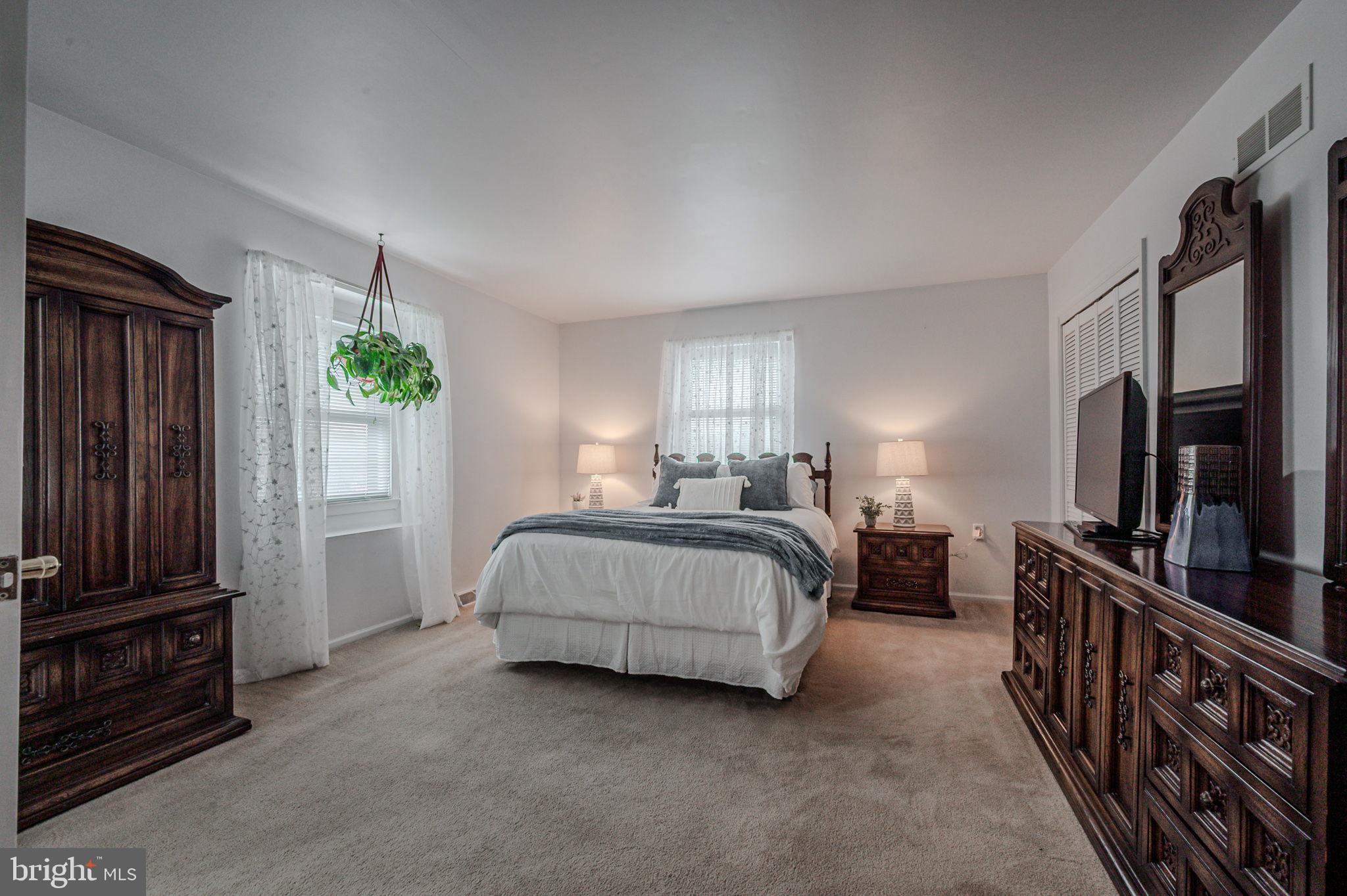 211 Old Ashley Drive Elkton, MD 21921 - Photo 34 of 50 a spacious bedroom with a bed and a flat screen tv