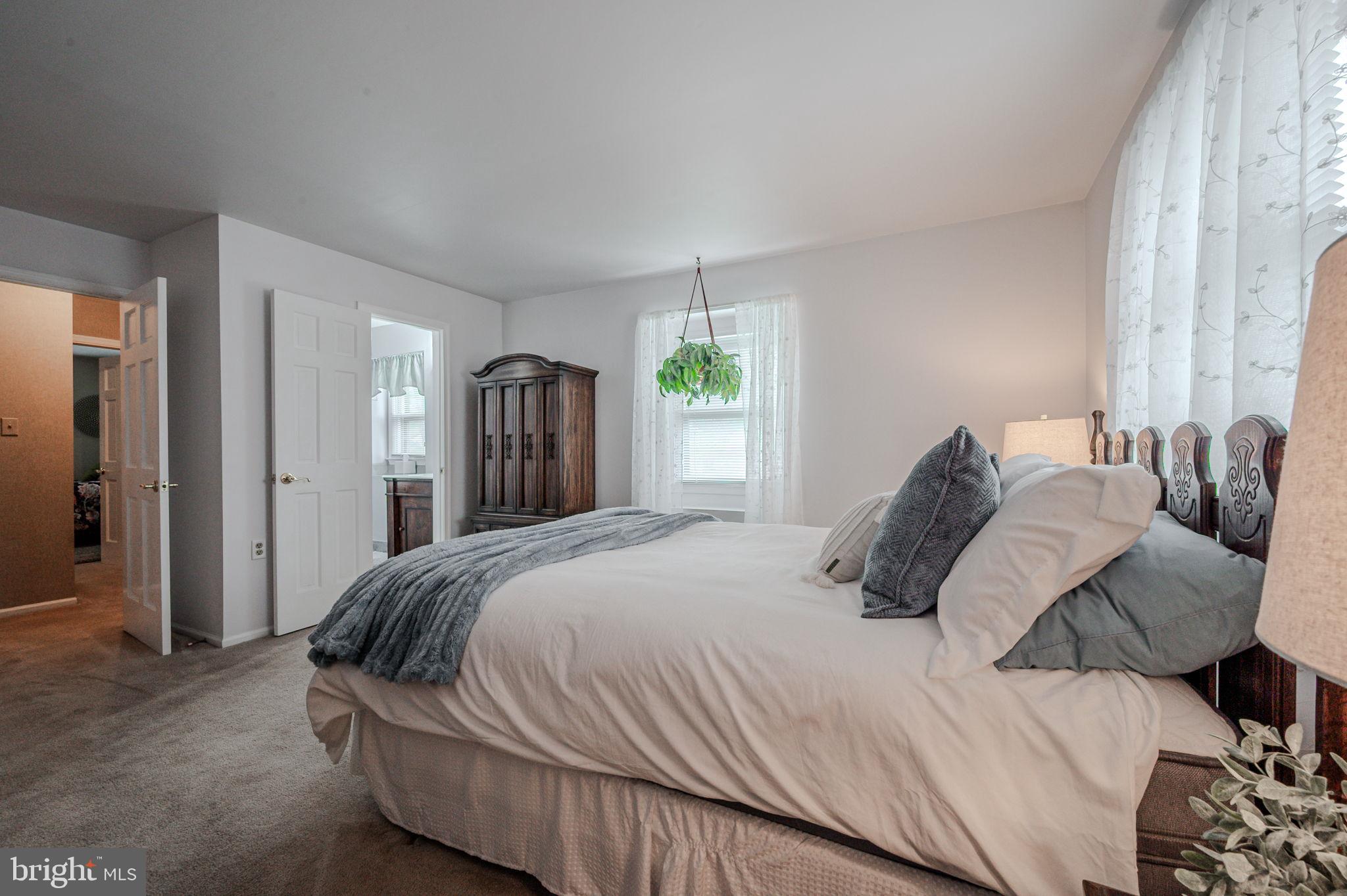 211 Old Ashley Drive Elkton, MD 21921 - Photo 35 of 50 a bedroom with a bed large mirror and a window
