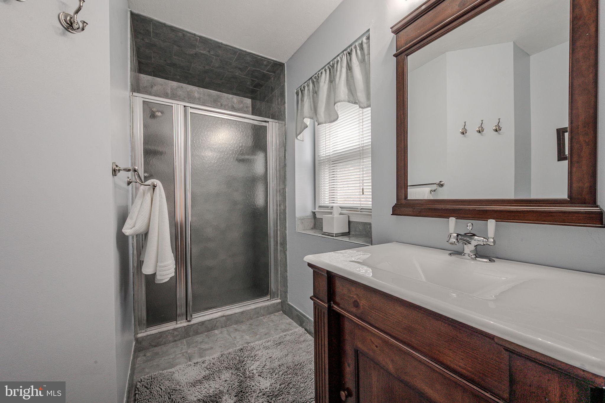 211 Old Ashley Drive Elkton, MD 21921 - Photo 36 of 50 a bathroom with a sink a shower and a mirror