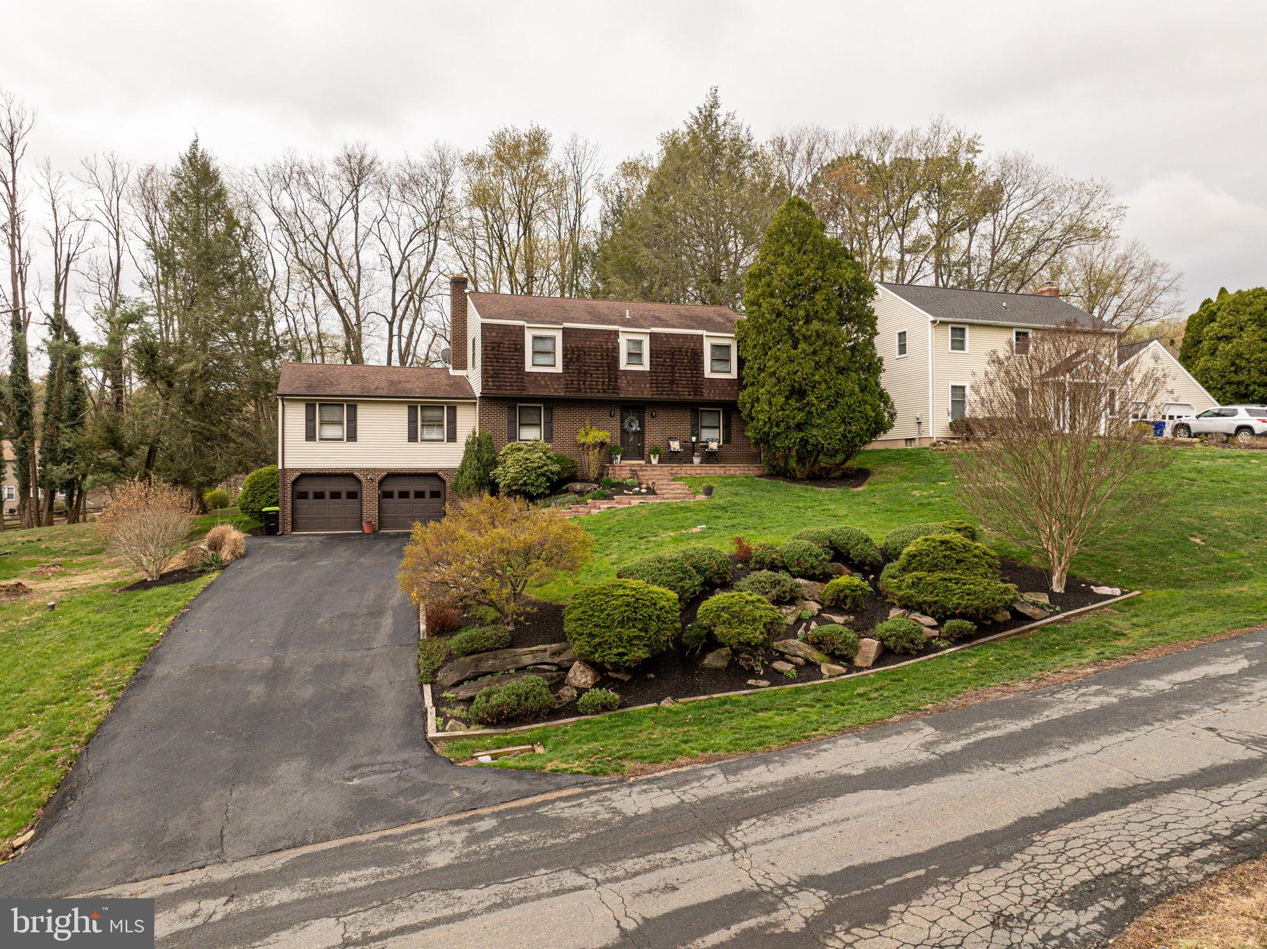 211 Old Ashley Drive Elkton, MD 21921 - Photo 42 of 50 a front view of a house with a garden and trees
