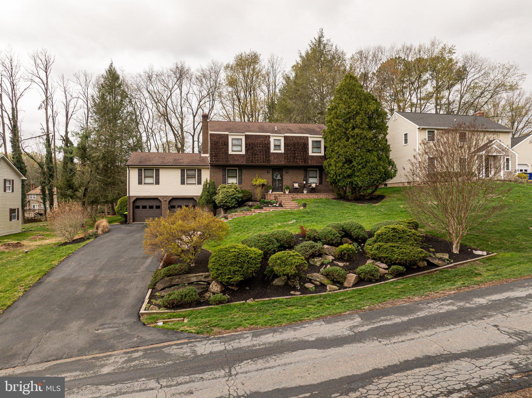 211 Old Ashley Drive Elkton, MD 21921 - Photo 43 of 50 a front view of a house with a garden and trees
