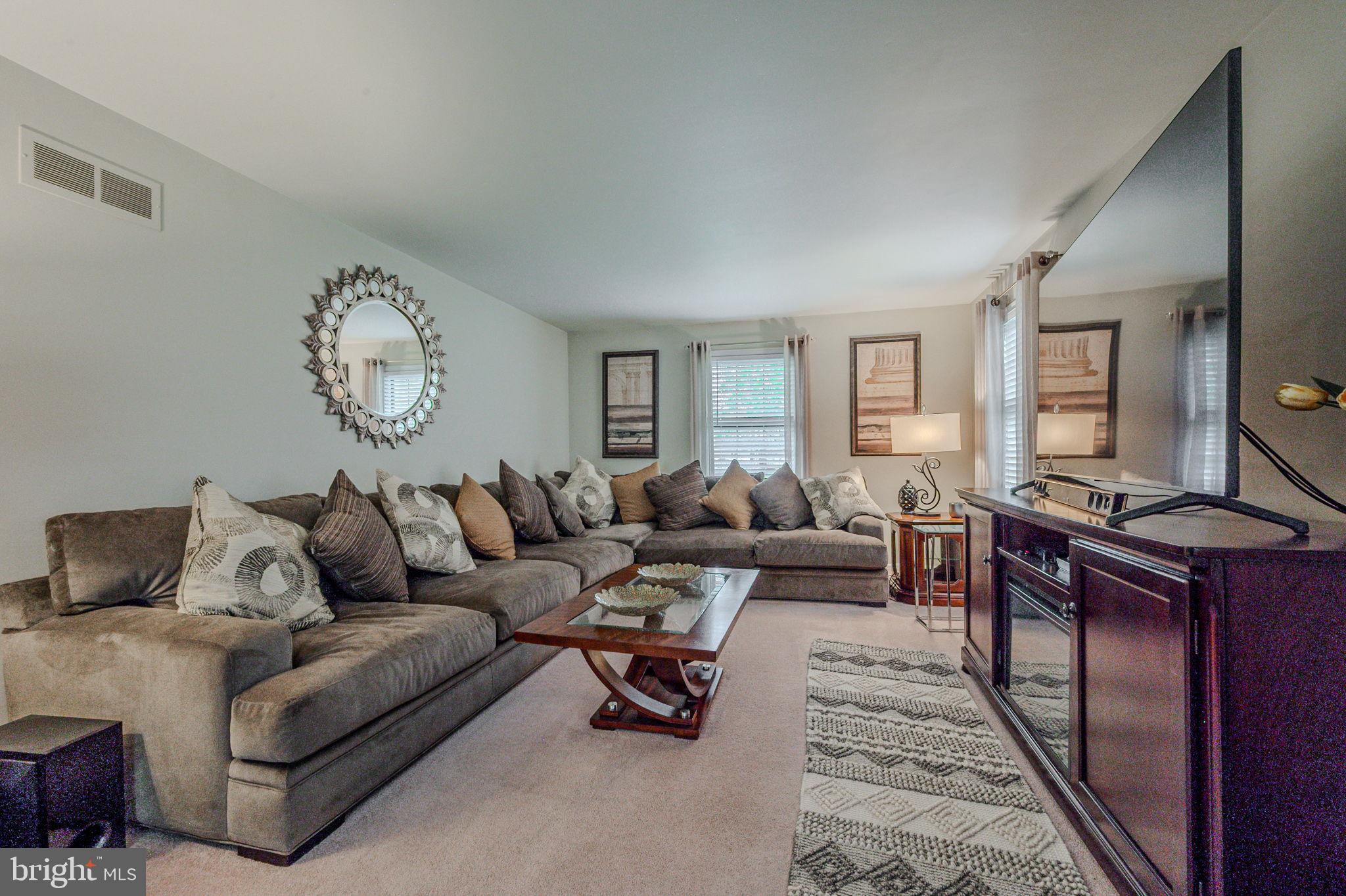 211 Old Ashley Drive Elkton, MD 21921 - Photo 7 of 50 a living room with furniture a clock on wall and a window