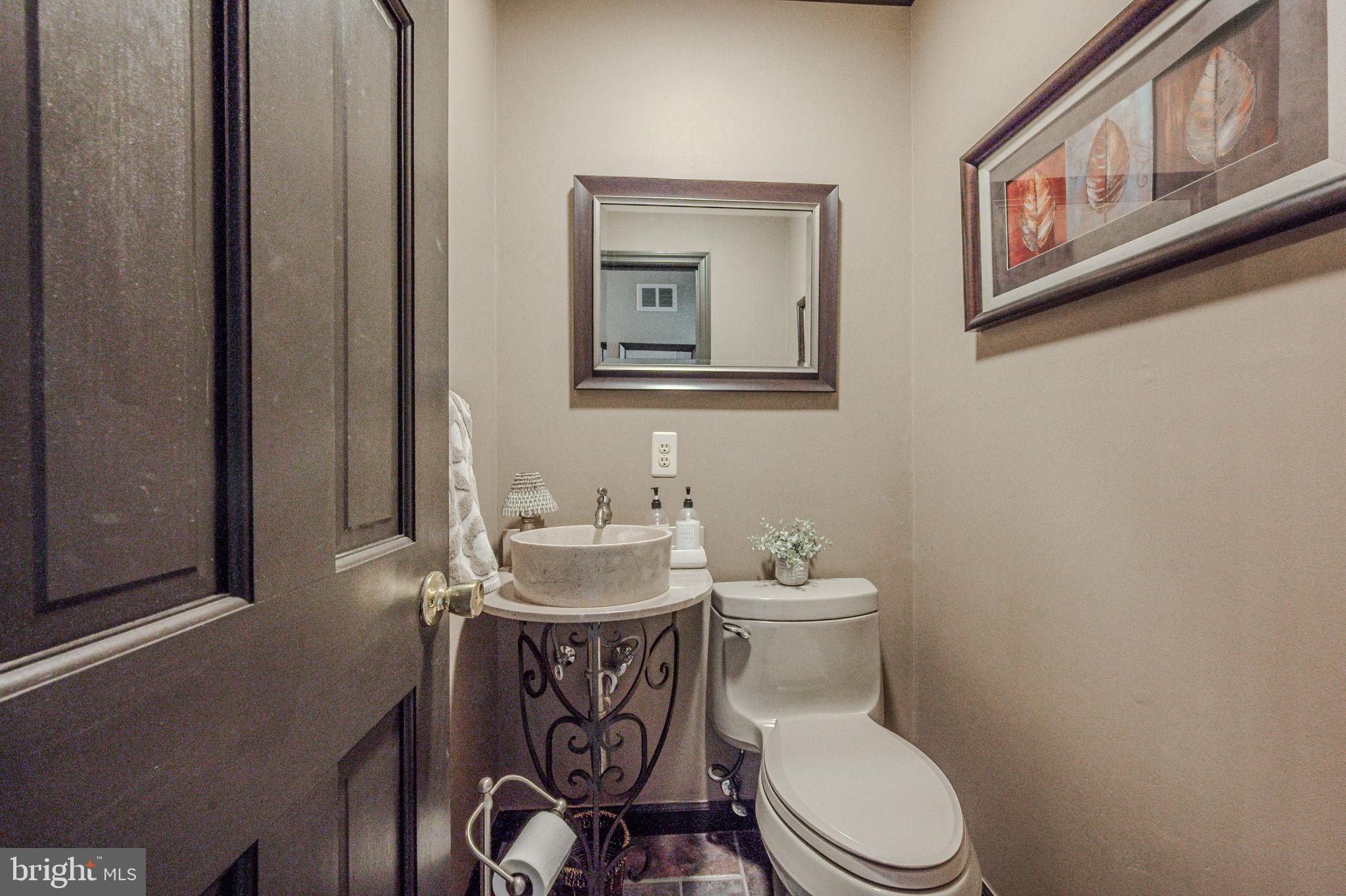 211 Old Ashley Drive Elkton, MD 21921 - Photo 9 of 50 a white toilet sitting next to a bathroom sink
