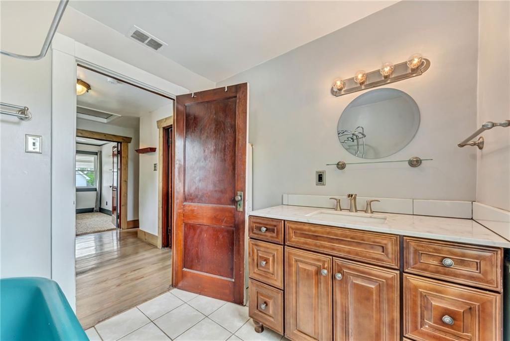 215 Independence Road Avella, PA 15312 - Photo 27 of 36 a bathroom with a sink a vanity and a mirror