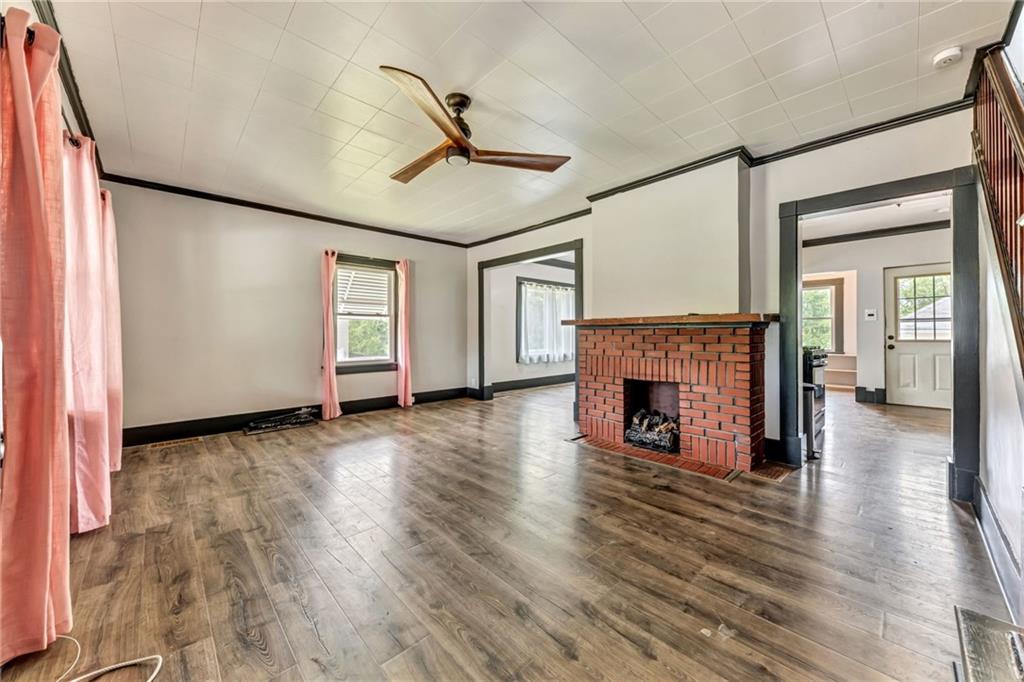 215 Independence Road Avella, PA 15312 - Photo 8 of 36 a view of a livingroom with a fireplace wooden floor and window