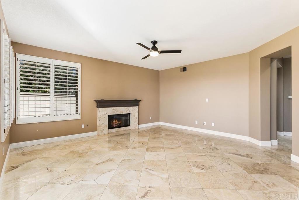 6947 Dusty Rose Place Carlsbad, CA 92011 - Photo 19 of 50 a view of a livingroom with a fireplace and window