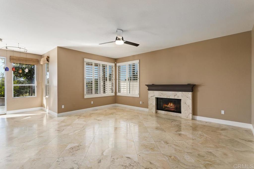 6947 Dusty Rose Place Carlsbad, CA 92011 - Photo 20 of 50 a view of an empty room with a fireplace and a window