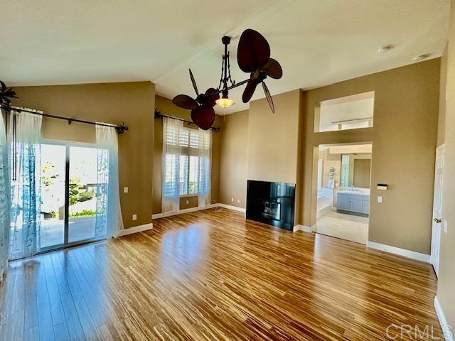 6947 Dusty Rose Place Carlsbad, CA 92011 - Photo 23 of 50 a view of a livingroom with wooden floor and a ceiling fan