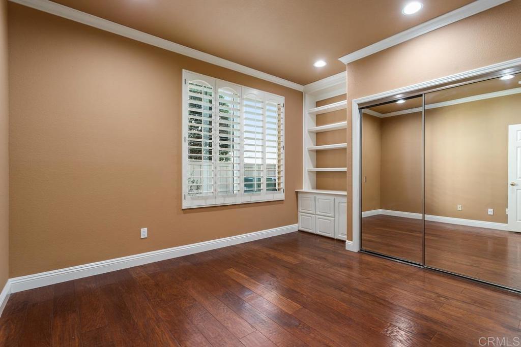 6947 Dusty Rose Place Carlsbad, CA 92011 - Photo 29 of 50 a view of an empty room with a window and wooden floor