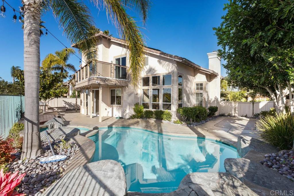 6947 Dusty Rose Place Carlsbad, CA 92011 - Photo 3 of 50 a view of a patio with couches table and chairs and potted plants