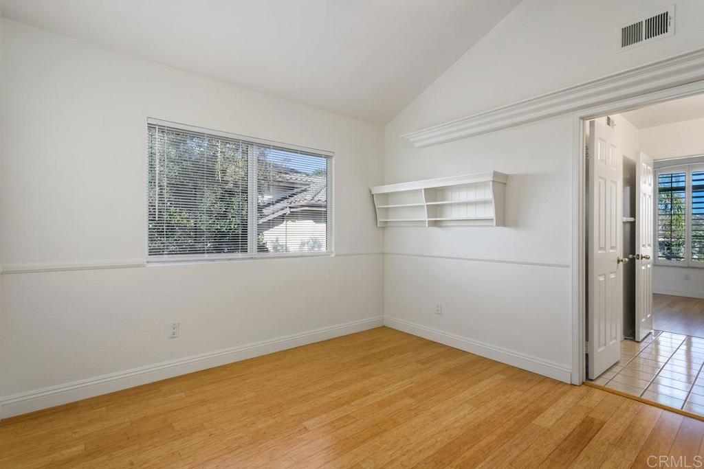 6947 Dusty Rose Place Carlsbad, CA 92011 - Photo 33 of 50 a view of empty room with wooden floor and fan