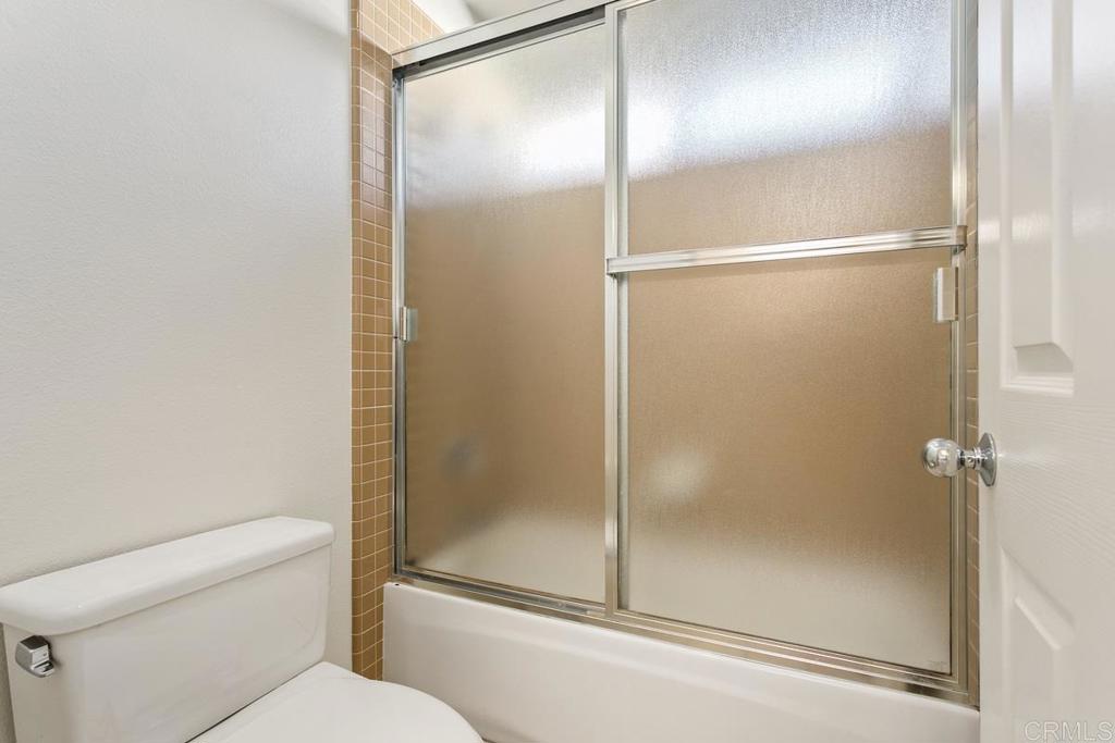 6947 Dusty Rose Place Carlsbad, CA 92011 - Photo 35 of 50 a bathroom with a glass shower door