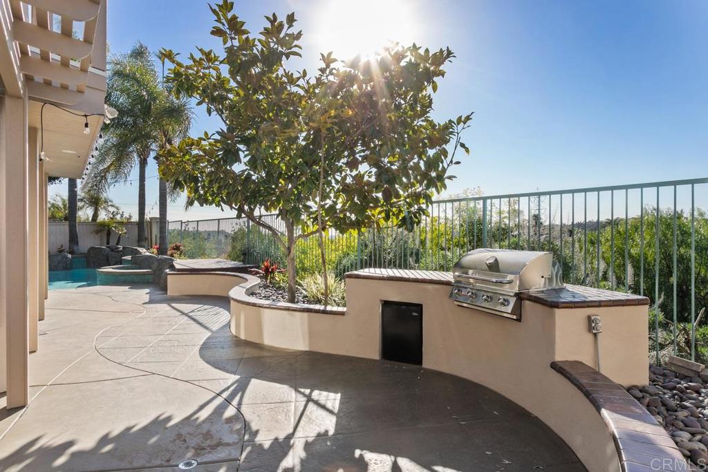 6947 Dusty Rose Place Carlsbad, CA 92011 - Photo 40 of 50 a view of a chair and tables back yard of the house