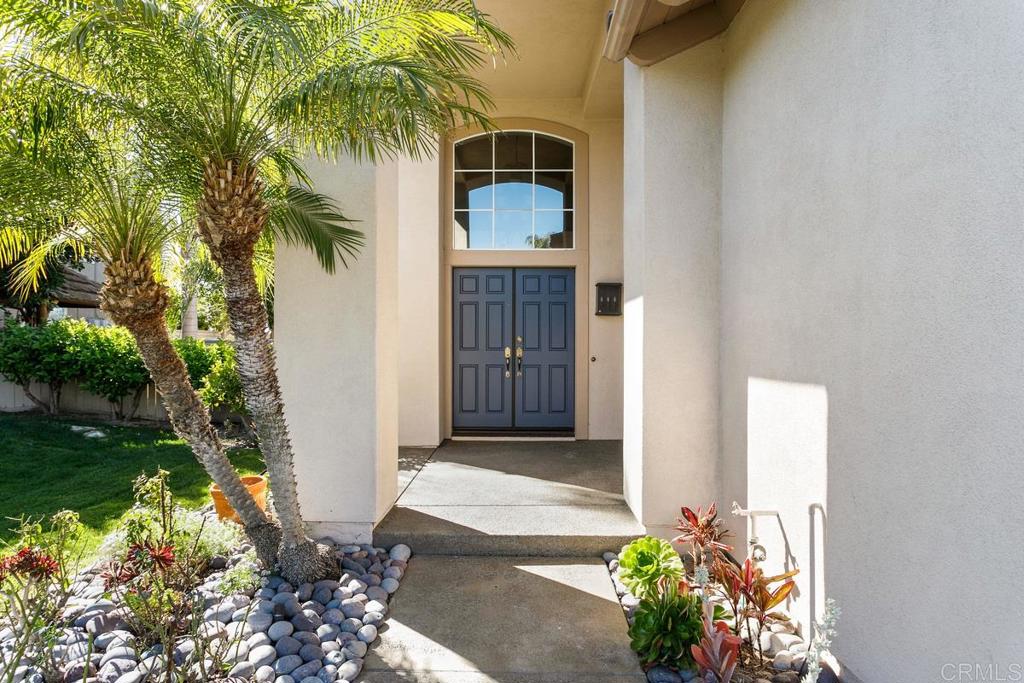 6947 Dusty Rose Place Carlsbad, CA 92011 - Photo 45 of 50 a front view of a house with a yard