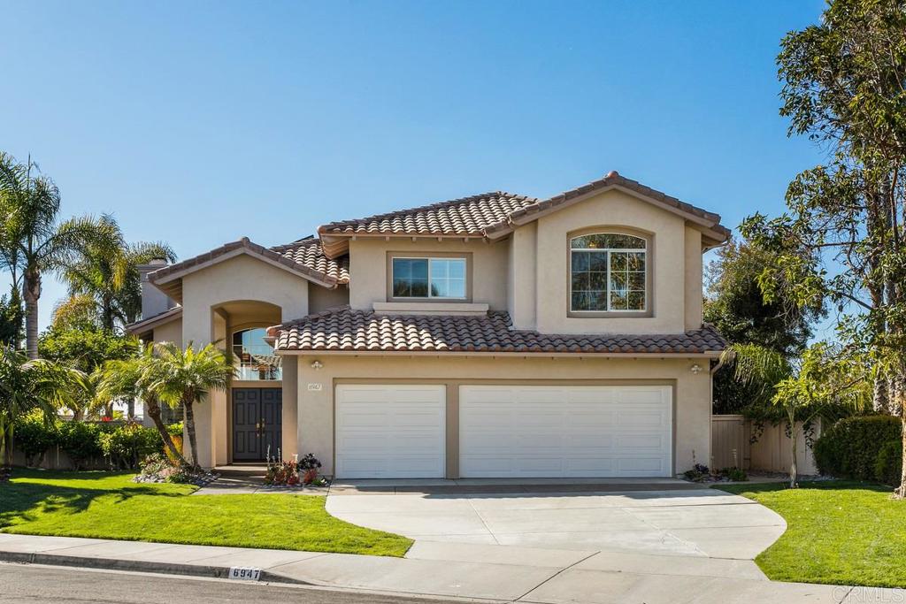 6947 Dusty Rose Place Carlsbad, CA 92011 - Photo 50 of 50 a front view of a house with a yard and garage