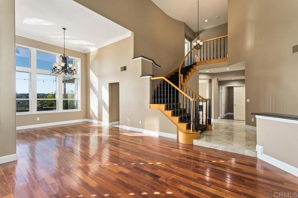 6947 Dusty Rose Place Carlsbad, CA 92011 - Photo 7 of 50 a view of an entryway with wooden floor