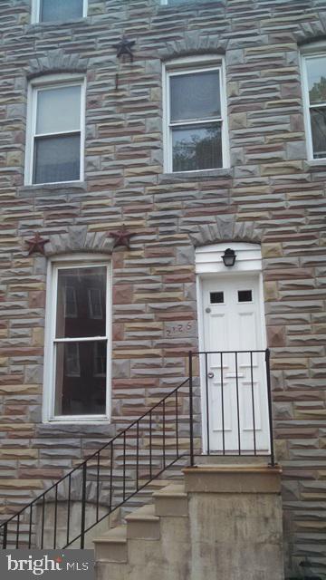 Charming stone facade with inviting entrance.