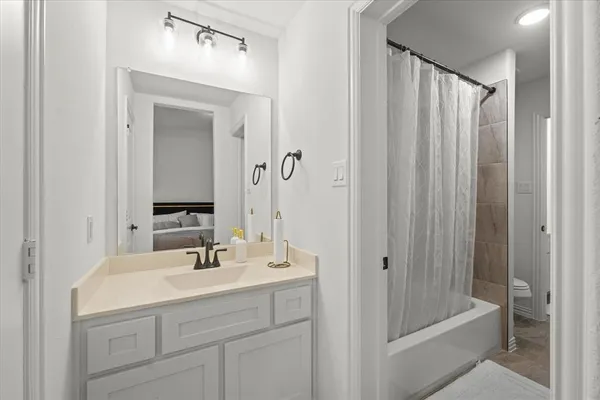 a bathroom with a shower a sink and a mirror