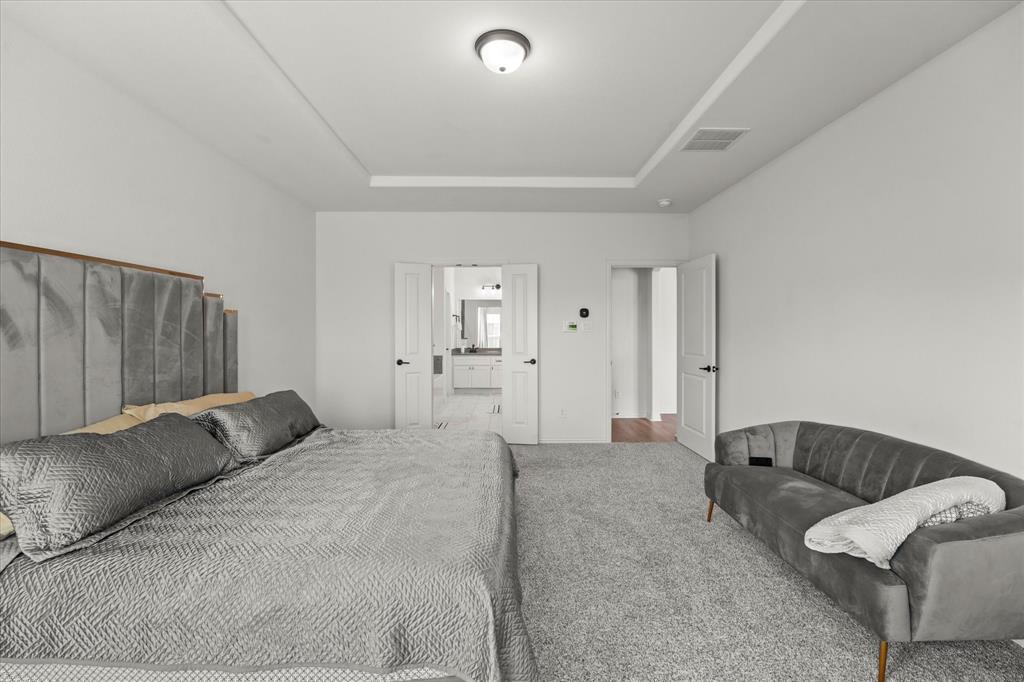 1111 Alaska Drive Forney, TX 75126 - Photo 17 of 30 a bedroom with a bed and a couch