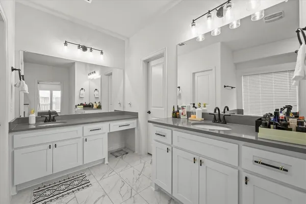 a bathroom with a sink vanity and mirror
