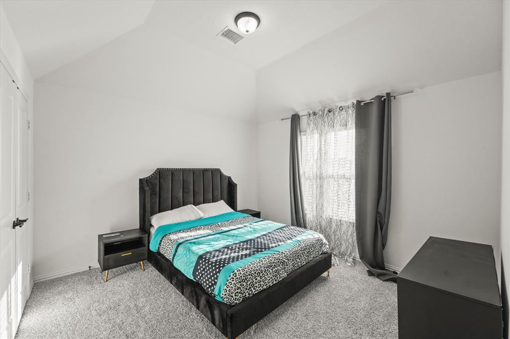 1111 Alaska Drive Forney, TX 75126 - Photo 24 of 30 a bedroom with a bed and a window