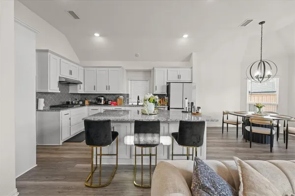 a kitchen with sink stove and cabinets