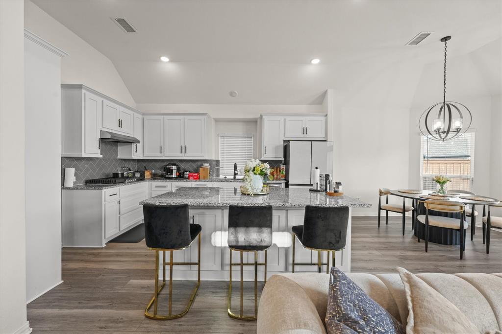 1111 Alaska Drive Forney, TX 75126 - Photo 27 of 30 a living room with stainless steel appliances kitchen island granite countertop furniture and a view of kitchen